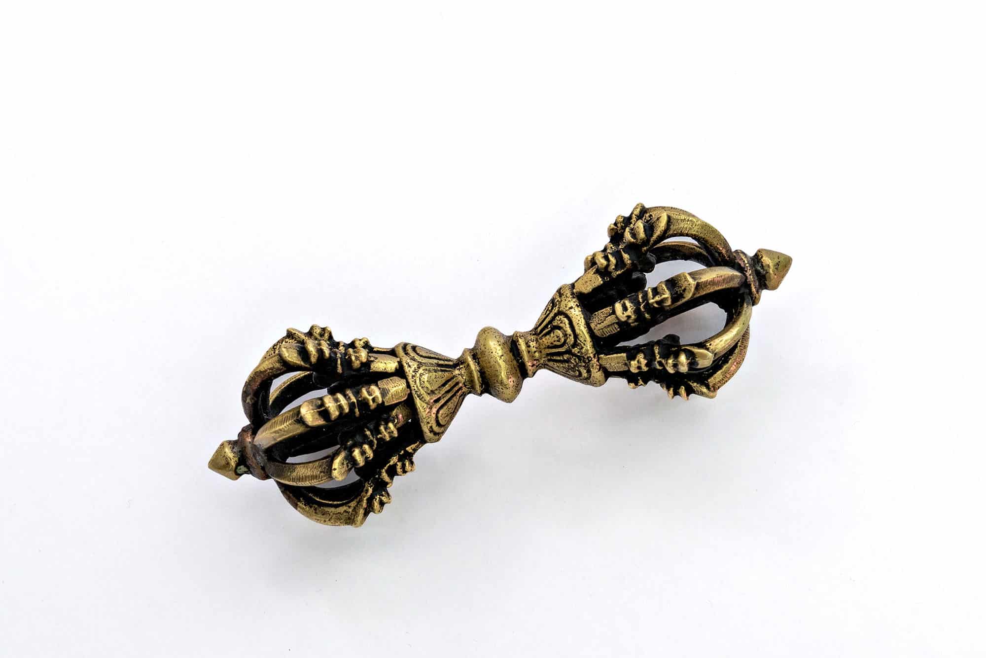 Antique brass Tibetan Buddhist vajra on white background